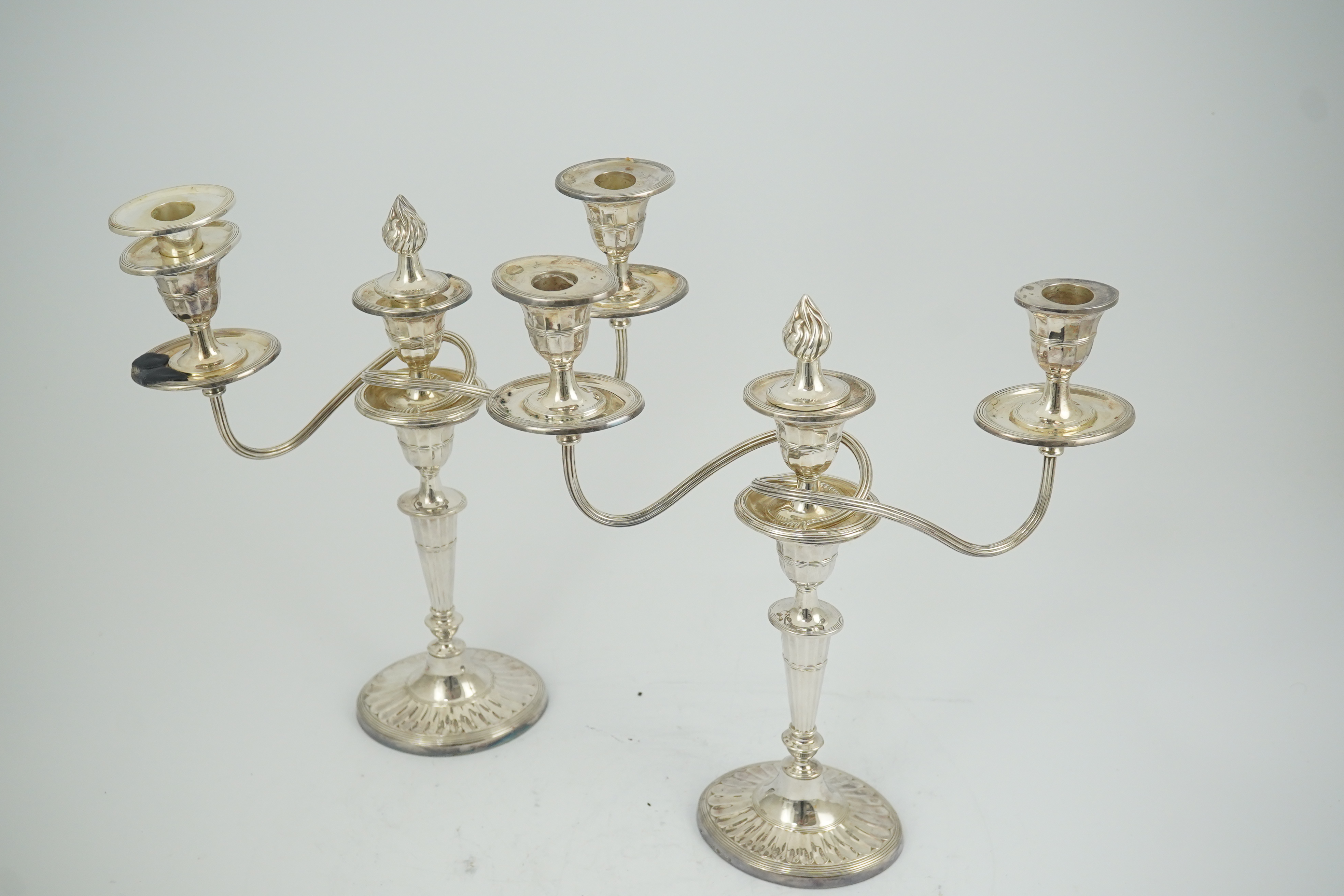 A modern pair of silver two branch three light oval candelabra, by James Dixon and Sons Ltd